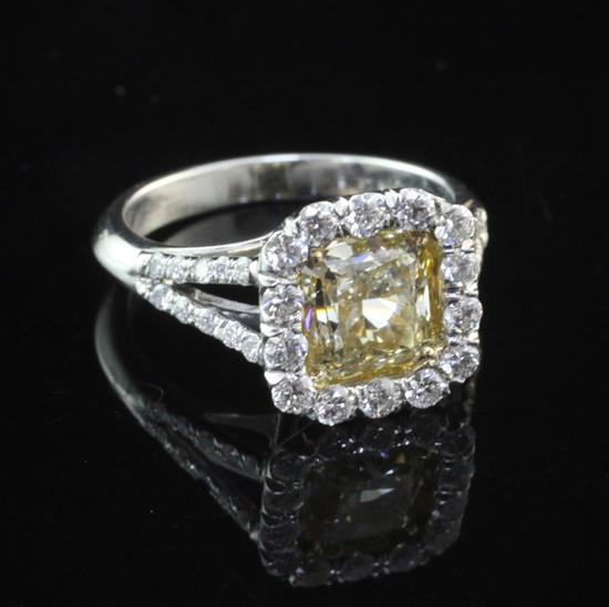 A platinum and single stone fancy vivid yellow diamond ring, size L.